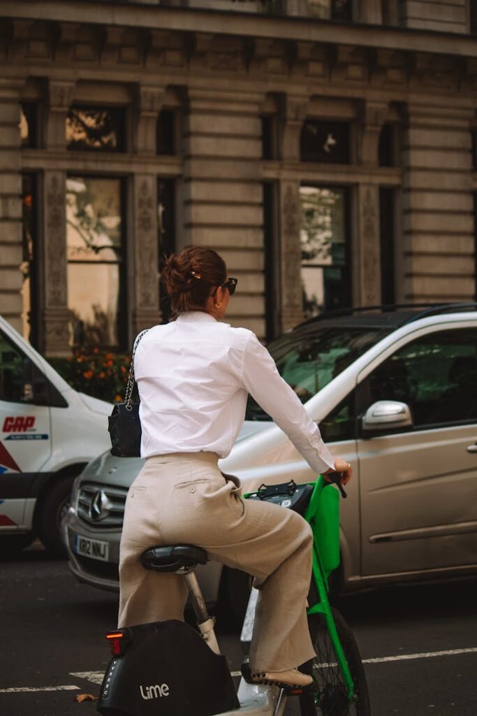 Elegant Woman Riding Electric Urban Bike in City